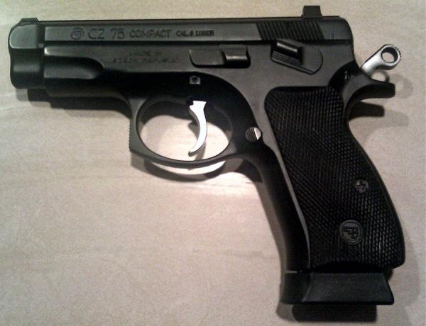 CZ 75 Compact with rubber grips, Trijicon night sights and a Mecgar 16 round magazine using an SP01 baseplate.
