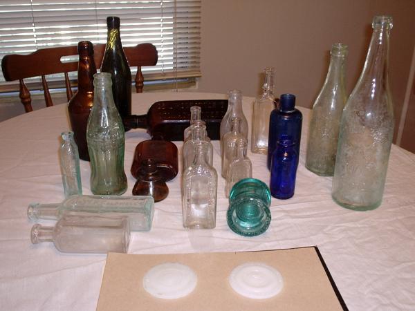 The two clear bottles on the right are from the "Indpls. Brewing Co." (Lady with wings on them)  The Coca-Cola bottle's bottom says Indpls,IN.
The two