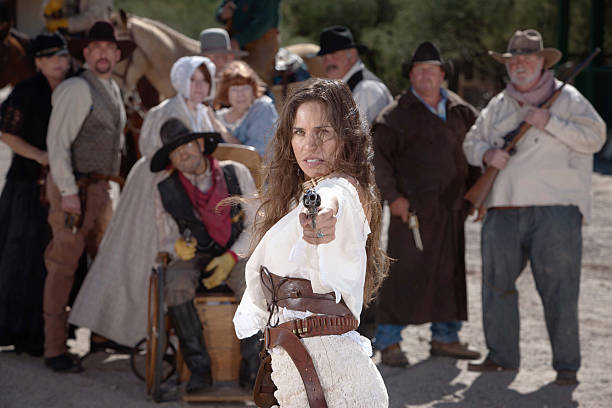 defiant-cowgirl-pointing-gun-picture-id153052804