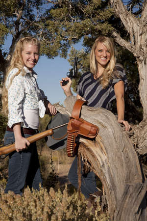 12104590-two-women-with-guns-in-the-out-doors-with-smiles-on-their-faces-.jpg